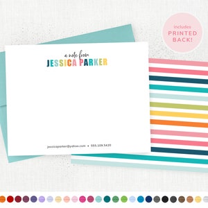 May include: A white card with a colorful rainbow-colored name "a note from JESSICA PARKER" at the top. The card has a blue envelope and a colorful striped back.