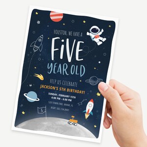 May include: A blue and black space-themed birthday invitation with a rocket, planets, stars, and an astronaut. The text reads "Houston, we have a five year old. Help us celebrate Jackson's 5th birthday! Sunday, February 15th, 4:00 PM - 6:00 PM, 520 Town End, Miami, FL, RSVP: 502.134.8901".