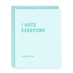 May include: A light blue greeting card with a matching envelope. The card features the text "I HATE EVERYONE" in a teal font, with "* EXCEPT YOU" below. The card is a humorous and sarcastic gift.