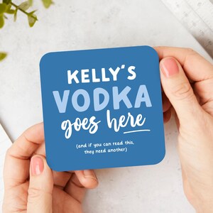 May include: Blue square coaster with the text "KELLY'S VODKA goes here (and if you can read this, they need another)"