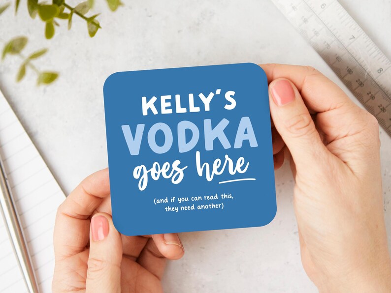 May include: Blue square coaster with the text "KELLY'S VODKA goes here (and if you can read this, they need another)"