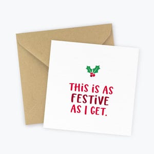 May include: A white card with a red and green holly design and the text "This is as festive as I get."