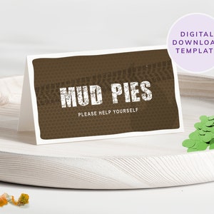 May include: Printable sign with a brown background and a tyre tread pattern. The text "MUD PIES" is in white with a distressed look. The text "PLEASE HELP YOURSELF" is in white below the title.