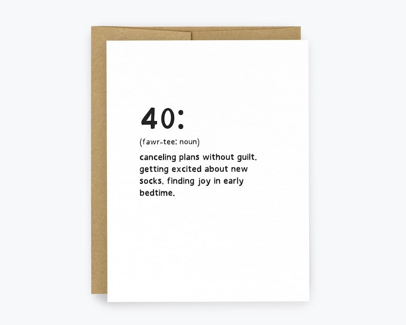 May include: A white greeting card with the number "40:" and a definition printed in black. The definition includes "canceling plans without guilt" and "finding joy in early bedtime." The card is inside a brown envelope.