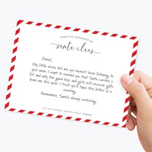 May include: A red and white striped card with a handwritten note from Santa Claus. The note says, "Daniel, My little elves tell me you haven't been listening to your mom. I want to remind you that Santa carries a list and only the good boys and girls will receive gifts from me this year. I trust you'll take this letter as a warning. Remember, Santa's always watching. 123 Elf Road, North Pole, 88888"