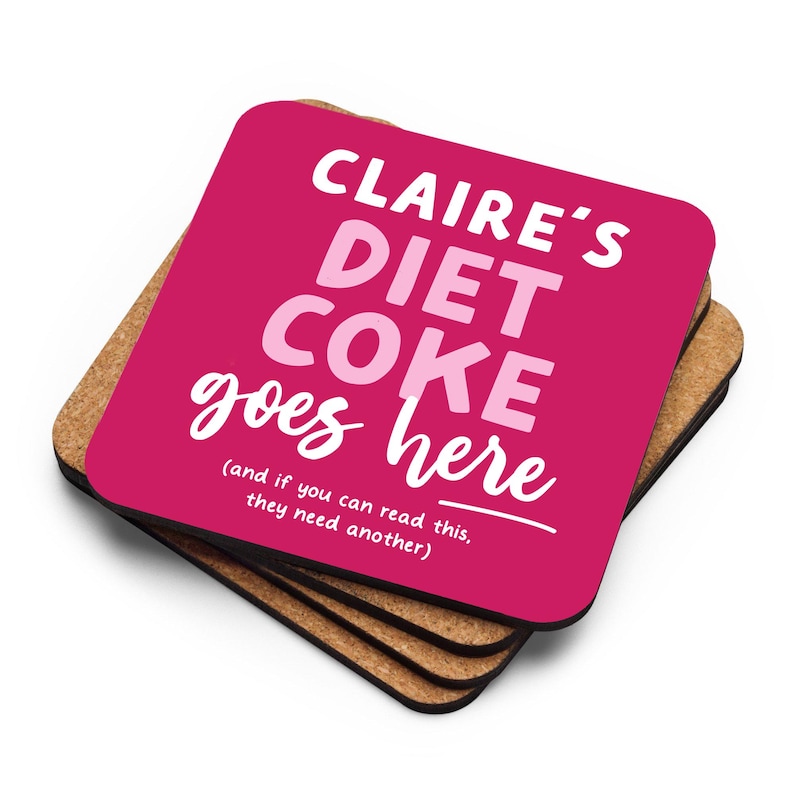 May include: Four pink and brown coasters with the text "CLAIRE'S DIET COKE goes here (and if you can read this, they need another)"