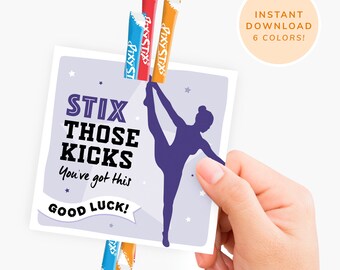 May include: A purple card with a silhouette of a gymnast doing a split. The card says "Stix Those Kicks You've got this Good Luck!" and has three PixyStix candy sticks attached to the bottom.