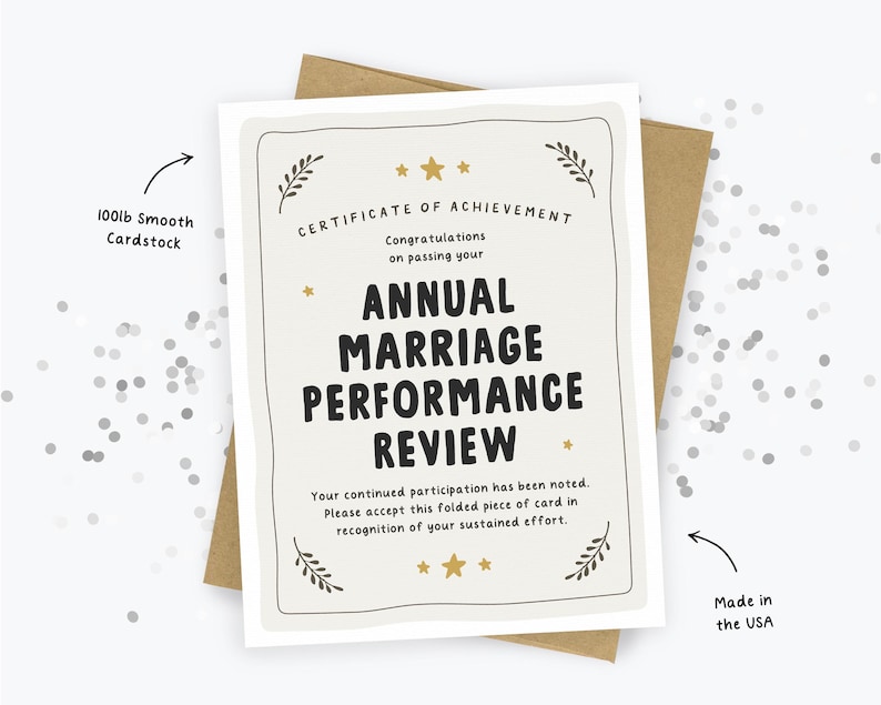 May include: A cream-colored greeting card featuring the text Certificate of Achievement, Congratulations on passing your Annual Marriage Performance Review, Your continued participation has been noted. Please accept this folded piece of card in recognition of your sustained effort. The card is printed on 100lb smooth cardstock and made in the USA.