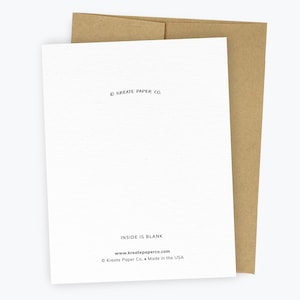 May include: A white greeting card with a brown kraft paper envelope. The back of the card features the text KREATE PAPER CO. at the top, and at the bottom, it reads INSIDE IS BLANK, www.kreatepaperco.com, and &copy; Kreate Paper Co. &bull; Made in the USA.