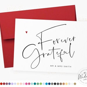 May include: A white card with black calligraphy that reads "Forever Grateful" with the names "MR & MRS SMITH" printed below. A small red heart is in the top left corner. The card is sitting on a red envelope.