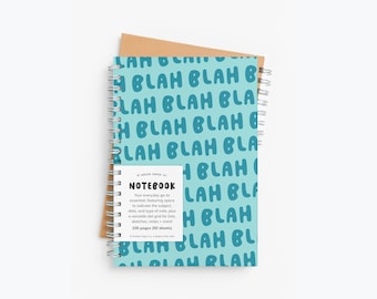 May include: A spiral-bound notebook with a light blue cover featuring the word "BLAH" repeated in a darker blue font. The notebook includes a dot grid and the text "NOTEBOOK" and "100 pages (50 sheets)". A brown paper backing is visible.