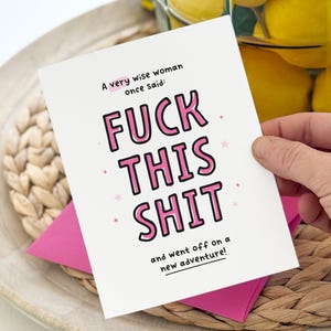 May include: A white greeting card with black and pink text that reads: A very wise woman once said: FUCK THIS SHIT and went off on a new adventure! The card features small pink stars scattered around the text and is paired with a bright pink envelope.