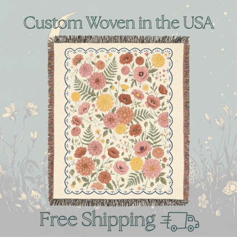 May include: Woven floral throw blanket featuring a cream background with a pattern of pink, yellow, and rust-colored flowers and green ferns. The blanket has a scalloped border and the text "Custom Woven in the USA".