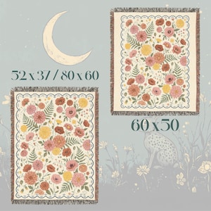 May include: Two floral throw blankets with fringed edges. One blanket is 52 x 37 inches, the other is 60 x 50 inches. The blankets feature a cream background with pink, orange, and yellow flowers and green fern leaves.