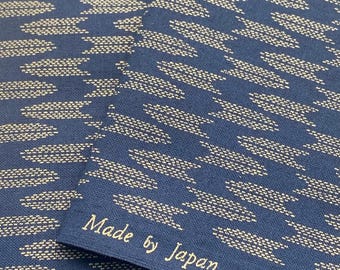 May include: Two pieces of dark blue fabric with a white geometric pattern. The fabric has the text "Made by Japan" printed on it.