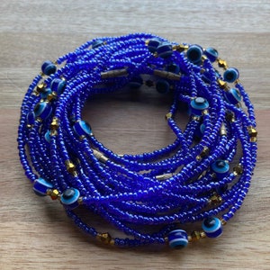 May include: A blue beaded waist bead with gold accents and blue evil eye charms.