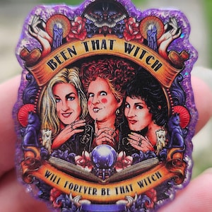 May include: A purple glitter sticker with a vintage-style illustration of three witches. The text reads "Been That Witch Will Forever Be That Witch".