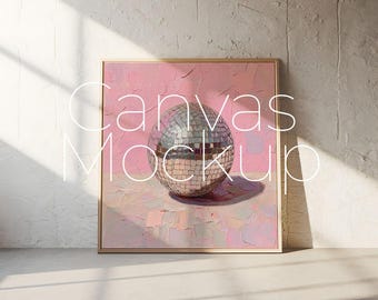 May include: A framed canvas print with a pink background and a silver disco ball in the center. The text "Canvas Mockup" is written in white letters over the image.
