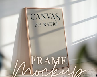 May include: A gold-toned frame mockup with a canvas insert. The canvas is beige and has the text "CANVAS 2:3 RATIO" printed on it. The frame is leaning against a white wall.