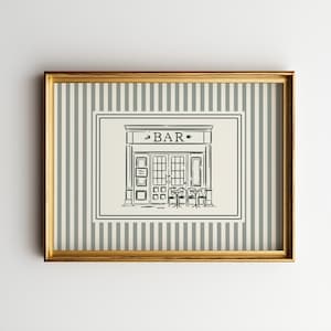 Op de afbeelding: Een ingelijste print met een zwart-wit illustratie van een bar, met het woord "BAR" boven de ingang. De achtergrond heeft een gestreept patroon in grijs en wit, en de lijst is goudkleurig.
