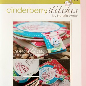 May include: A needle case and book jacket sewing pattern featuring a birdcage design with a bird on a branch. The pattern is called "Sketch & Stitch" and is by Natalie Lymer.