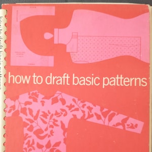 May include: A red and pink book titled "how to draft basic patterns." The cover features illustrations of dress patterns and a diagram. The book's spine is white with text. Authors' names are listed at the bottom.