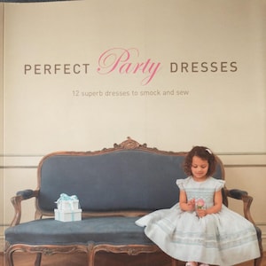 May include: A book cover titled "PERFECT Party DRESSES" with a young girl in a light blue dress holding a flower, seated on a blue antique sofa. The book promises 12 dresses to smock and sew.