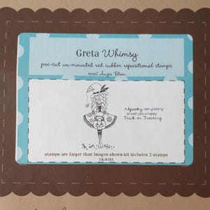 May include: A package of Greta Whimsy pre-cut, un-mounted red rubber repositional stamps. The package features a light blue background with white polka dots and a brown scalloped border. The stamps include a drawing of a witch holding a pumpkin and the text "A spooky little greeting to wish you a happy Trick or Treating."