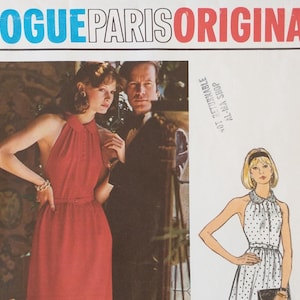 May include: A Vogue Paris Original sewing pattern envelope featuring a photograph of a person in a red halter dress with a collar and a button-down front. Beside it is a fashion illustration of the same dress in a white fabric with black polka dots.
