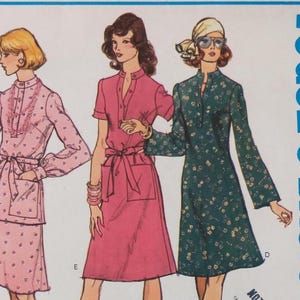 May include: A Vogue's Basic sewing pattern illustration featuring three dress designs. One light pink dress with long sleeves and a lace collar, a solid pink short-sleeved dress with a tie waist, and a dark green floral dress with long sleeves.