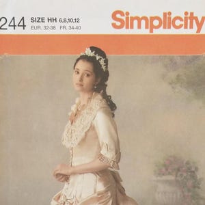 May include: A Simplicity 4244 sewing pattern envelope for size HH 6, 8, 10, 12. The cover features a photograph of a person wearing a cream-colored gown with a large lace collar, three-quarter length sleeves with pleated cuffs, and a floral headpiece.