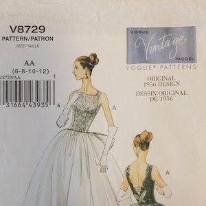 May include: A vintage Vogue pattern, V8729, featuring a 1956 design. The pattern includes illustrations of a formal gown with a full skirt and fitted bodice. The pattern size is AA (6-8-10-12). The Vogue Vintage Model logo is visible.