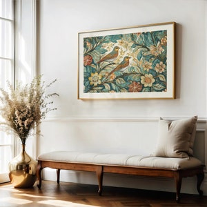 May include: A gold framed print of two birds perched on a branch in a lush green and blue floral pattern.