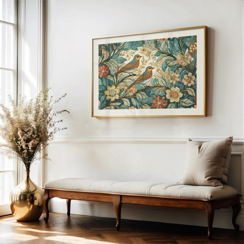 May include: A gold framed print of two birds perched on a branch in a lush green and blue floral pattern.