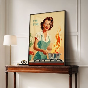 May include: A vintage-style poster featuring a woman in a green apron standing in a kitchen. She is holding a pot with flames coming out of it. The text "I'M FINE" is printed in the top left corner of the poster.