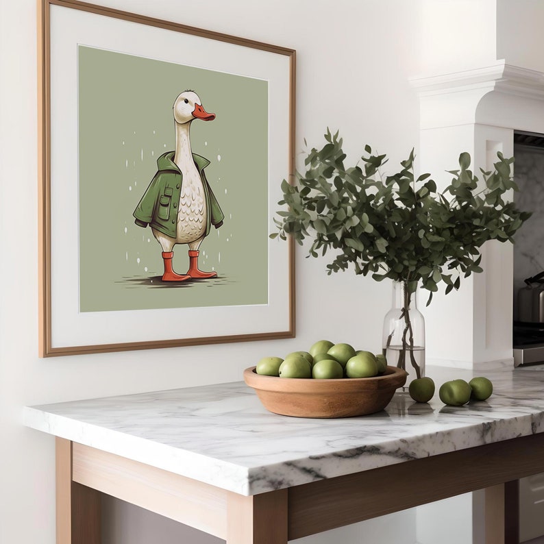 May include: A framed illustration of a white goose wearing a green jacket and red rain boots, standing on a green background with raindrops falling.