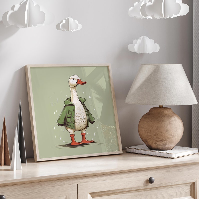 May include: A framed illustration of a white goose wearing a green jacket and red boots. The goose is standing on a green background with white snowflakes.