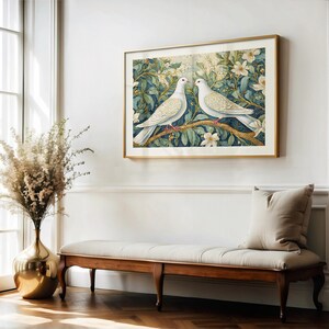 May include: A framed print of two white doves perched on a branch of a flowering tree. The doves are facing each other and the background is a blue and green watercolor wash.