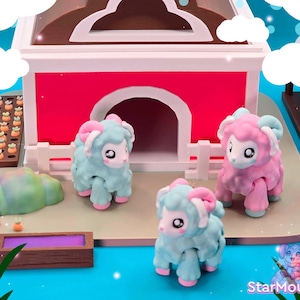 May include: A whimsical scene featuring toy sheep in shades of blue and pink, with curled horns and expressive eyes. They are positioned near a red and white barn, with miniature farm elements like a trough and garden.