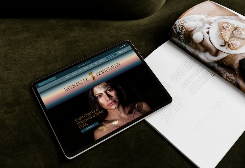 May include: A website homepage for Mystical & Bohemian, a business that offers services to help people gain clarity and discover a new path. The website features a woman with gold makeup and a dark background.