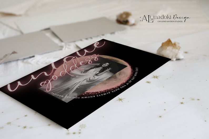 May include: A black card with pink and white text that reads "unique goddess" and "Live your life as you have always known you are magical". The card features a photo of a woman in a white dress with a pink moon behind her.