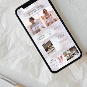May include: A smartphone displays a website with the text "Nourishing Coaching for the Spirit and Soul." The site features images of women, products, and the phrases "Grab Your Free Guide" and "Shop Healing."