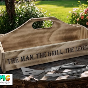 May include: A wooden grilling tool caddy with a handle. The caddy has the text "The Man, The Grill, The Legend" engraved on the front.