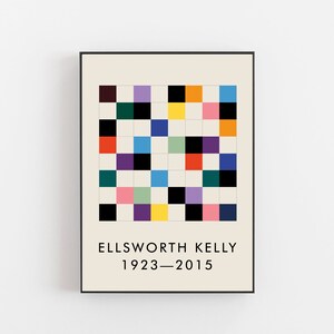 May include: A black and white framed print with a colorful geometric pattern and the text "ELLSWORTH KELLY 1923-2015".