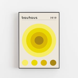 May include: A minimalist poster with the text "bauhaus 1919" and a yellow concentric circle design. The poster includes a color palette of five yellow circles.