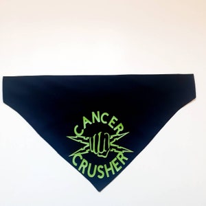 May include: Black bandana with a green "Cancer Crusher" logo featuring a fist and lightning bolts.