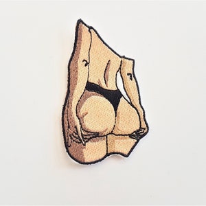 May include: Embroidered patch featuring a cartoon illustration of a person's back in black underwear.