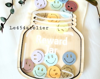 May include: Wooden reward jar with a clear plastic front, decorated with the words "Reward Jar". The jar is filled with colorful smiley face tokens.