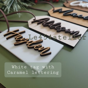 May include: White gift tag with the name "Hayden" written in brown cursive lettering.