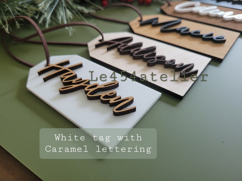 May include: White gift tag with the name "Hayden" written in brown cursive lettering.